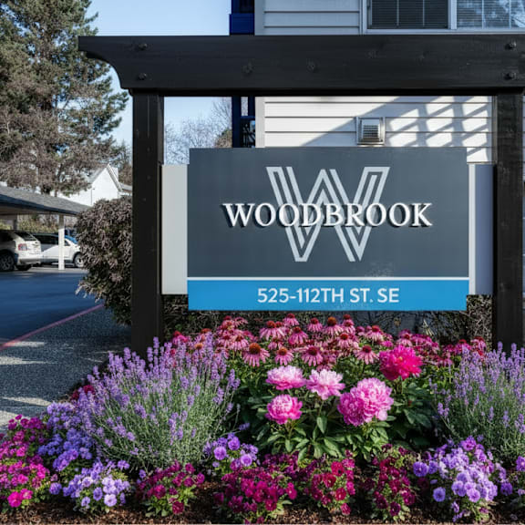 A sign for Woodbrook is displayed in front of a building.