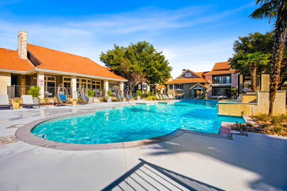 a swimming pool in front of a house with a resort style pool at The Amethyst, Austin, TX, 78727