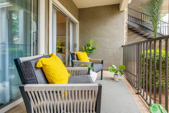 a balcony with a couch and chairs on it at The Amethyst, Austin, Texas