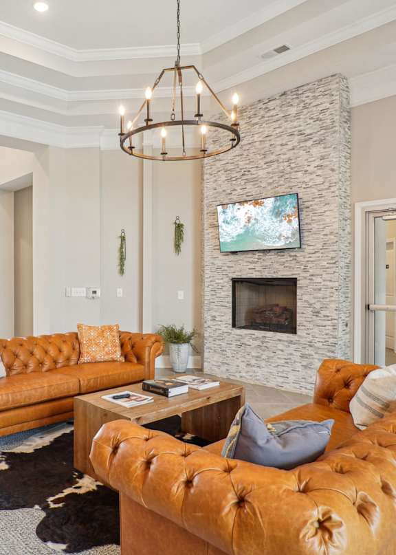 A living room with a large couch and a fireplace.