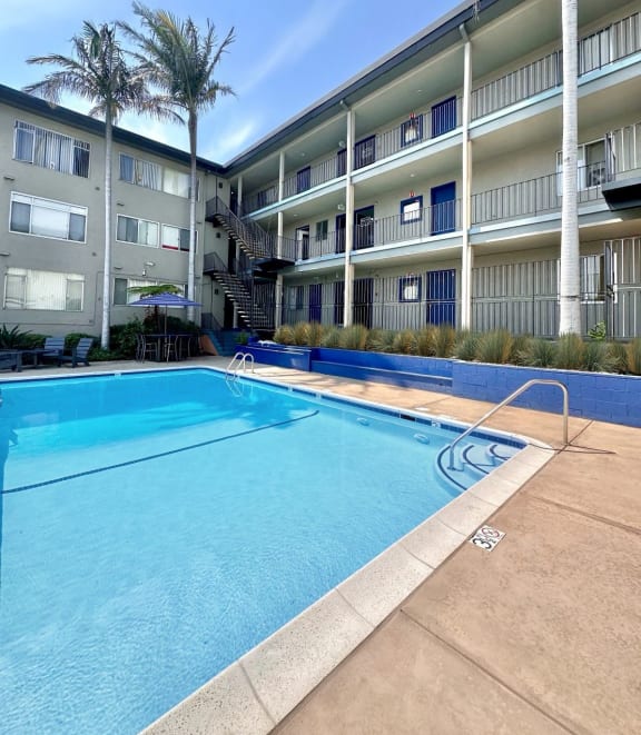 a swimming pool with a building in the background at The Chase Apartment Homes, Oakland, CA