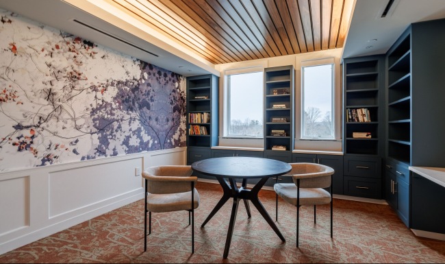 a table and chairs in a room with wallpaper