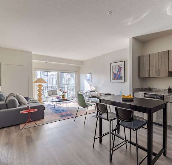 A modern kitchen with a dining table and chairs.