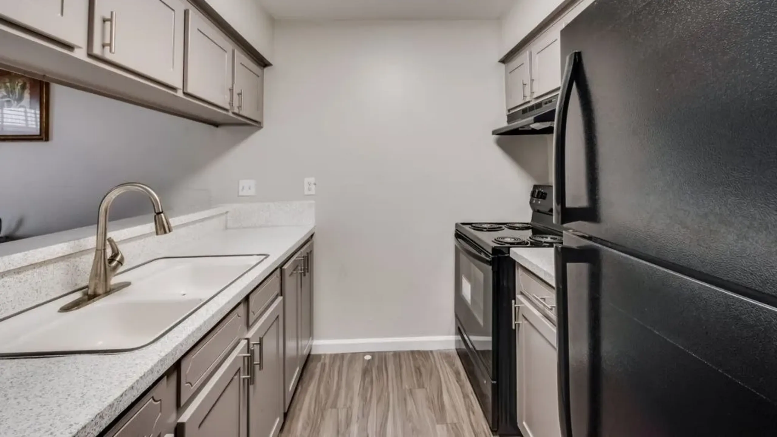 Modern kitchen with sleek black appliances, elegant countertops, and ample cabinet space for stylish living.