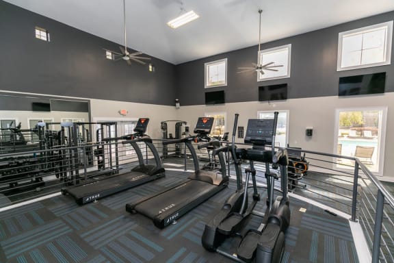 a gym with cardio equipment at the monarch apartments in midtown at Deerfield Village, Alpharetta