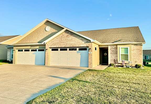 a house with a driveway and a garage door  at Hawthorne Properties in Lafayette, IN 47905