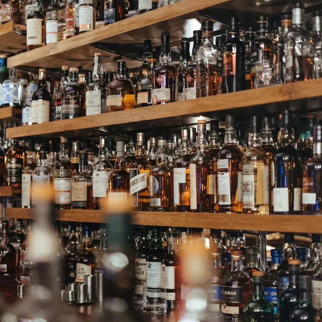Shelves filled with various bottles of whiskey and spirits.