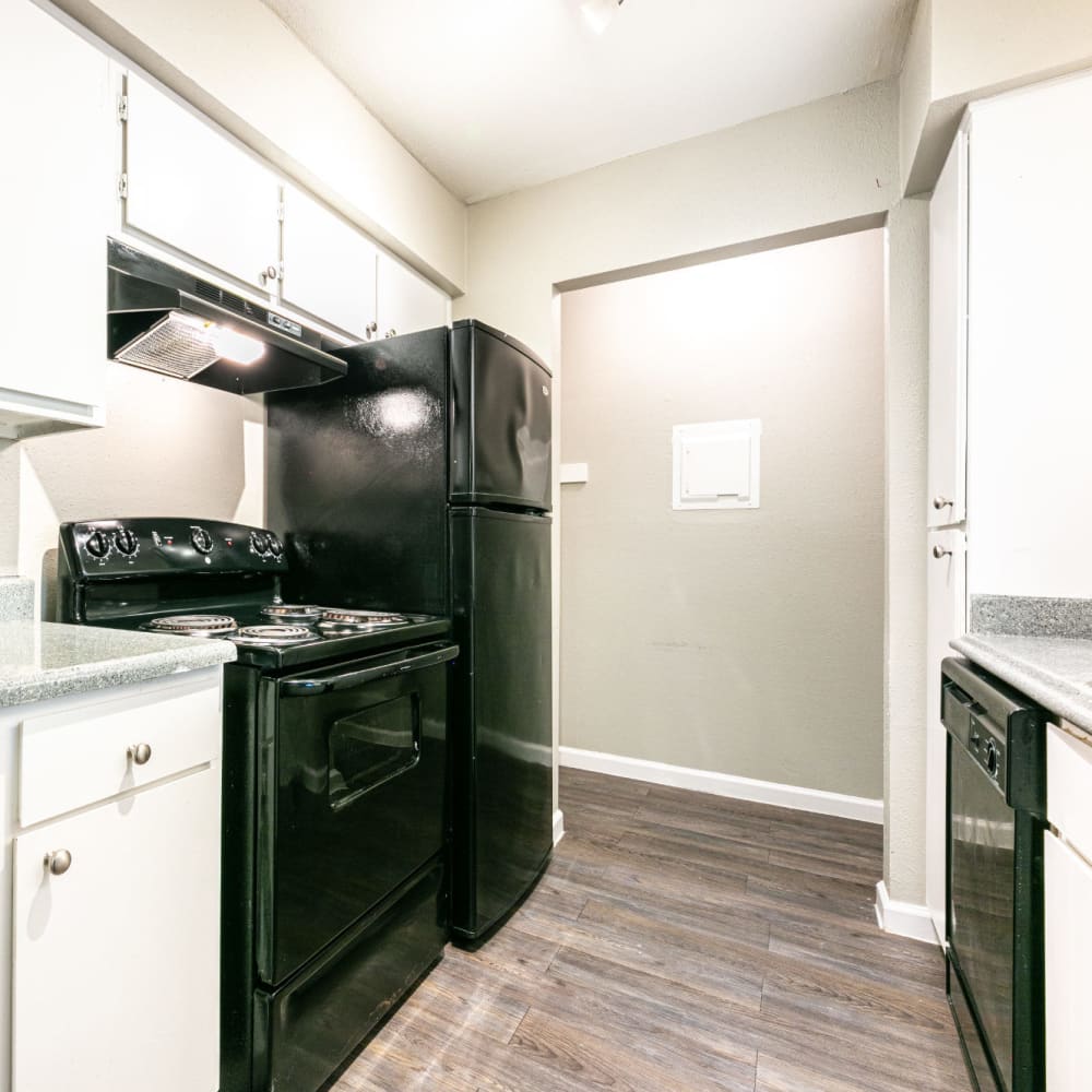 Apartment kitchen with black appliances at The One at 5959 in Houston, Texas