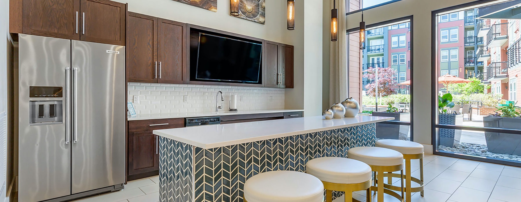 Resident kitchen area with large windows and island