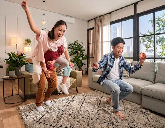 Two people are dancing in a living room.