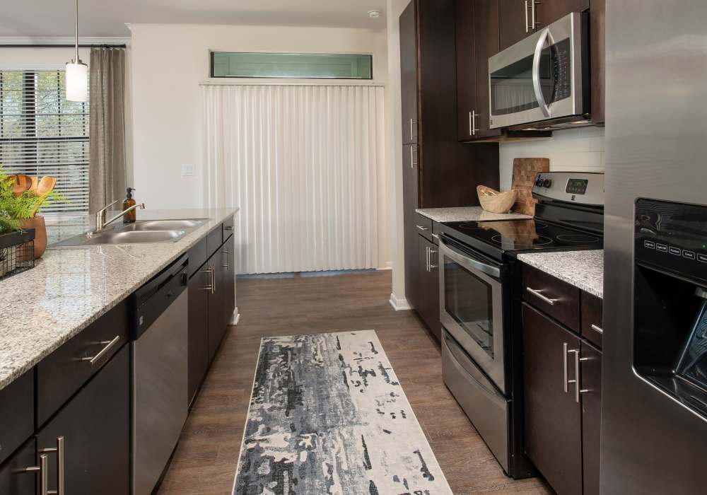 Kitchen with island and appliances at Nantucket at Fannin Station in Houston, Texas