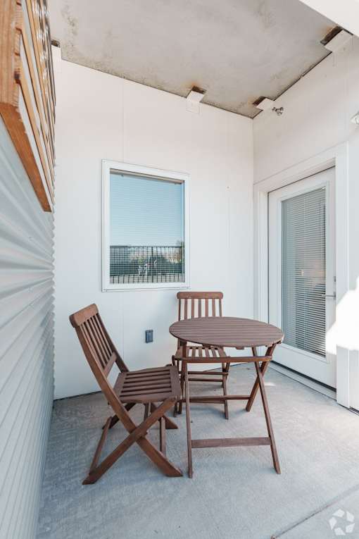 A patio with a table and two chairs.