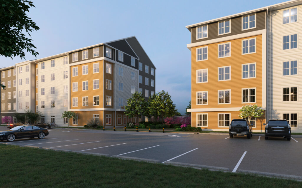 The modern Alexan Quinn apartment buildings standing near an asphalt parking lot featuring parked cars.