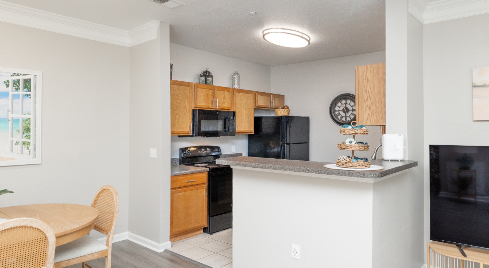 a kitchen with a black refrigerator
