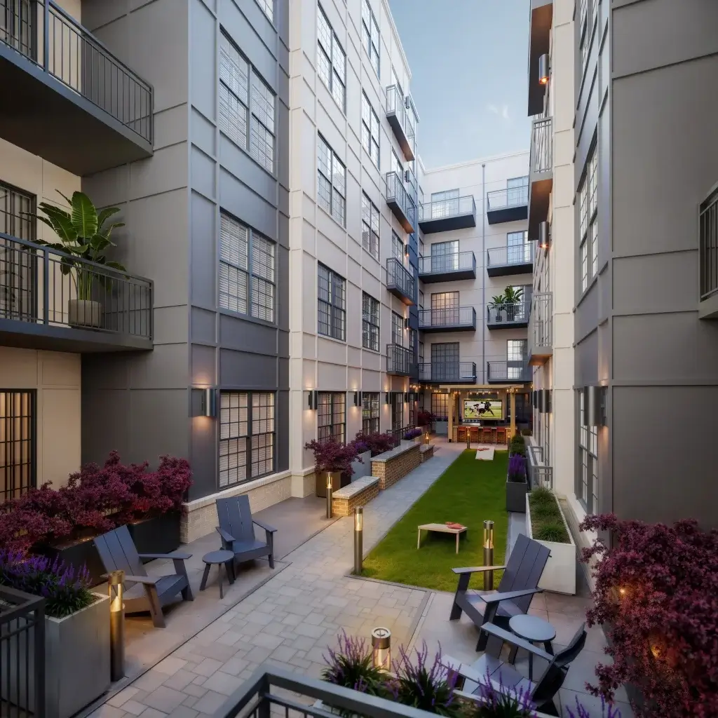 Outdoor courtyard at Signature on Grand featuring grilling areas, cornhole, fire pits, and comfortable lounge seating for UT students.