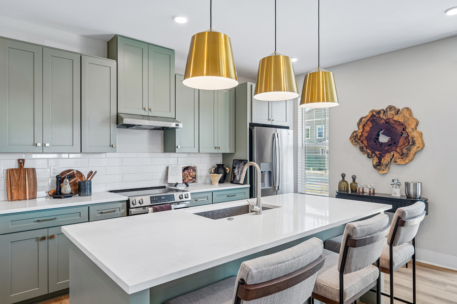 kitchen at HARMON Ascend with green cabinets