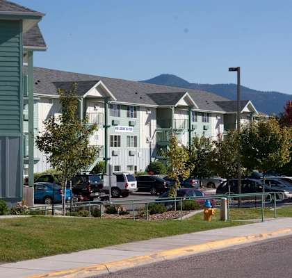 row of houses with cars parked B at Great Northern, Montana