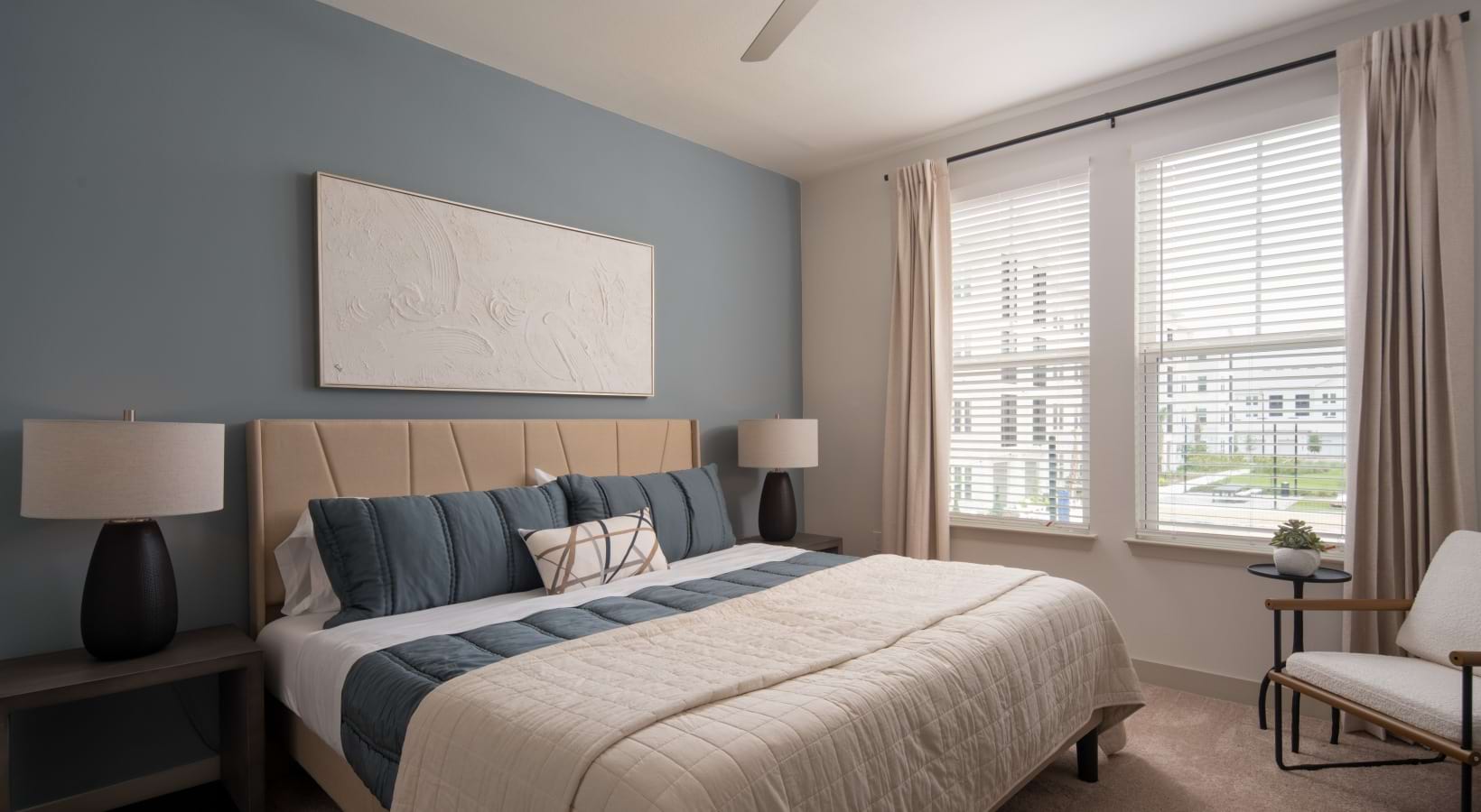 a bedroom with a bed and a fan