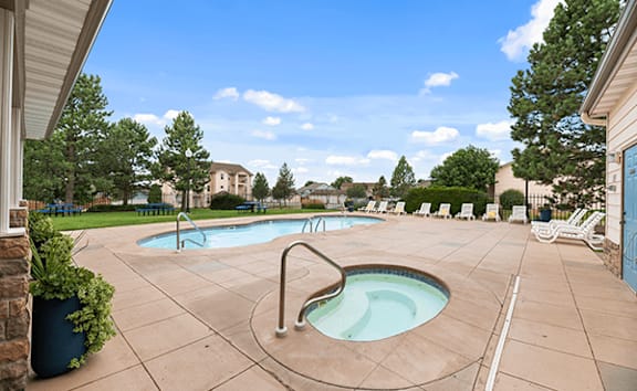 A pool with a hot tub in the middle of it.