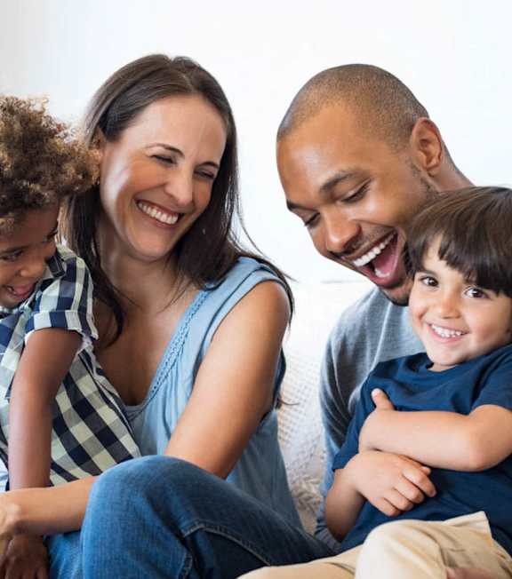 A family laughing in a bed at Arlington Farms, Greenwood, 46143