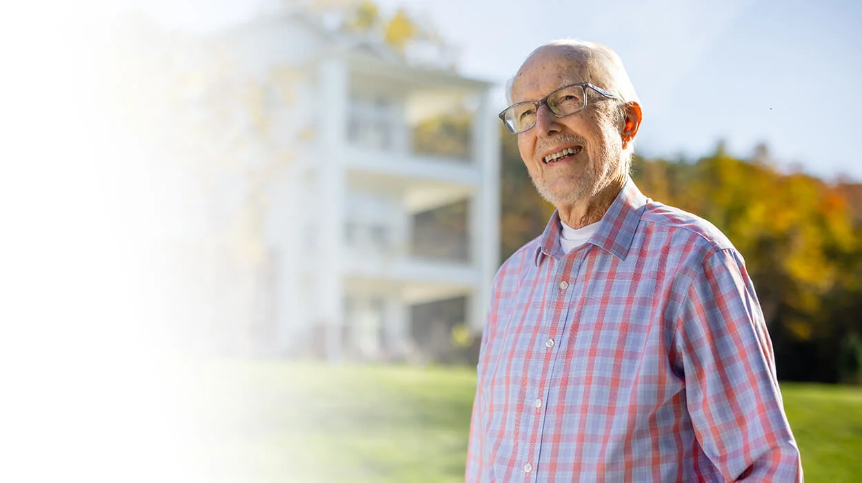 man walking outside, smiling