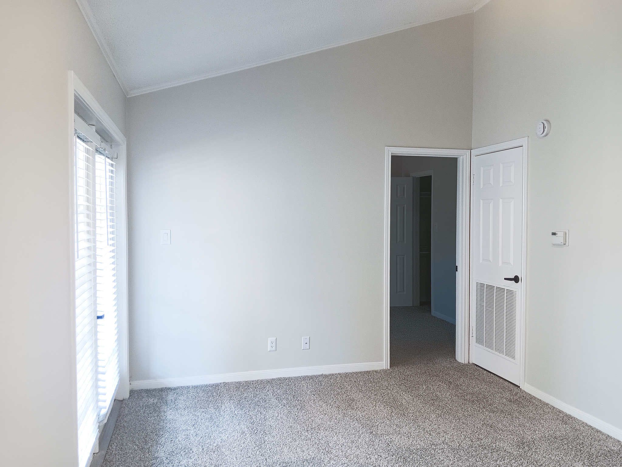 Unfurnished apartment bedroom with carpeting at The Woodlands