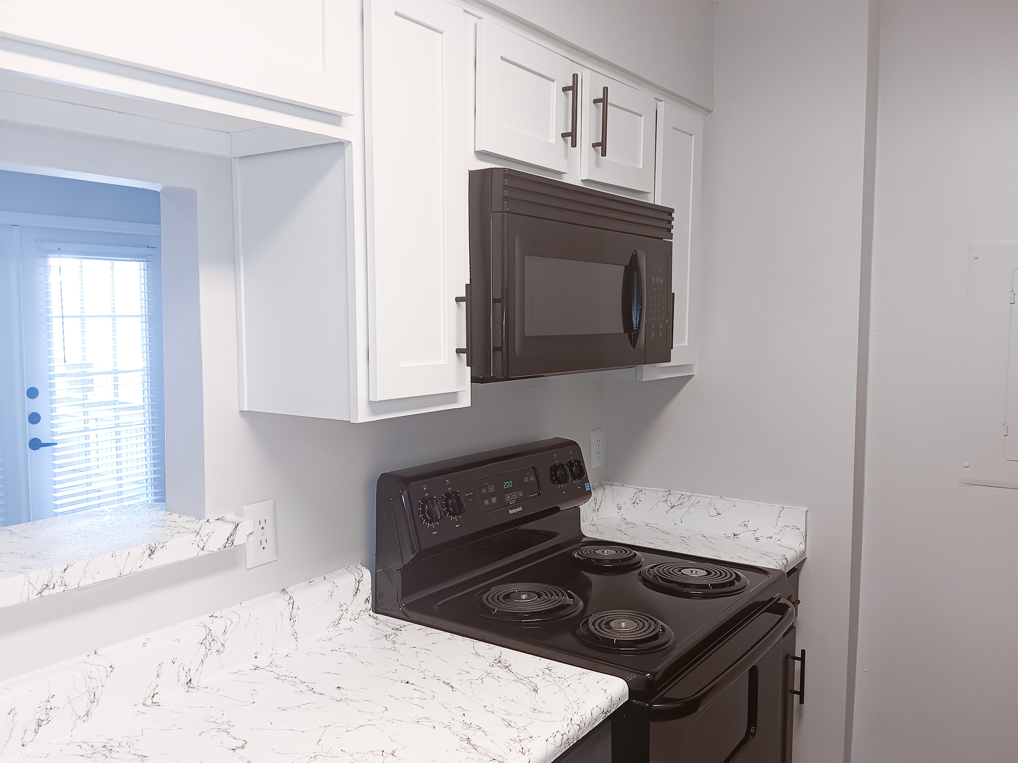 Black appliances inside apartment kitchens at The Woodlands