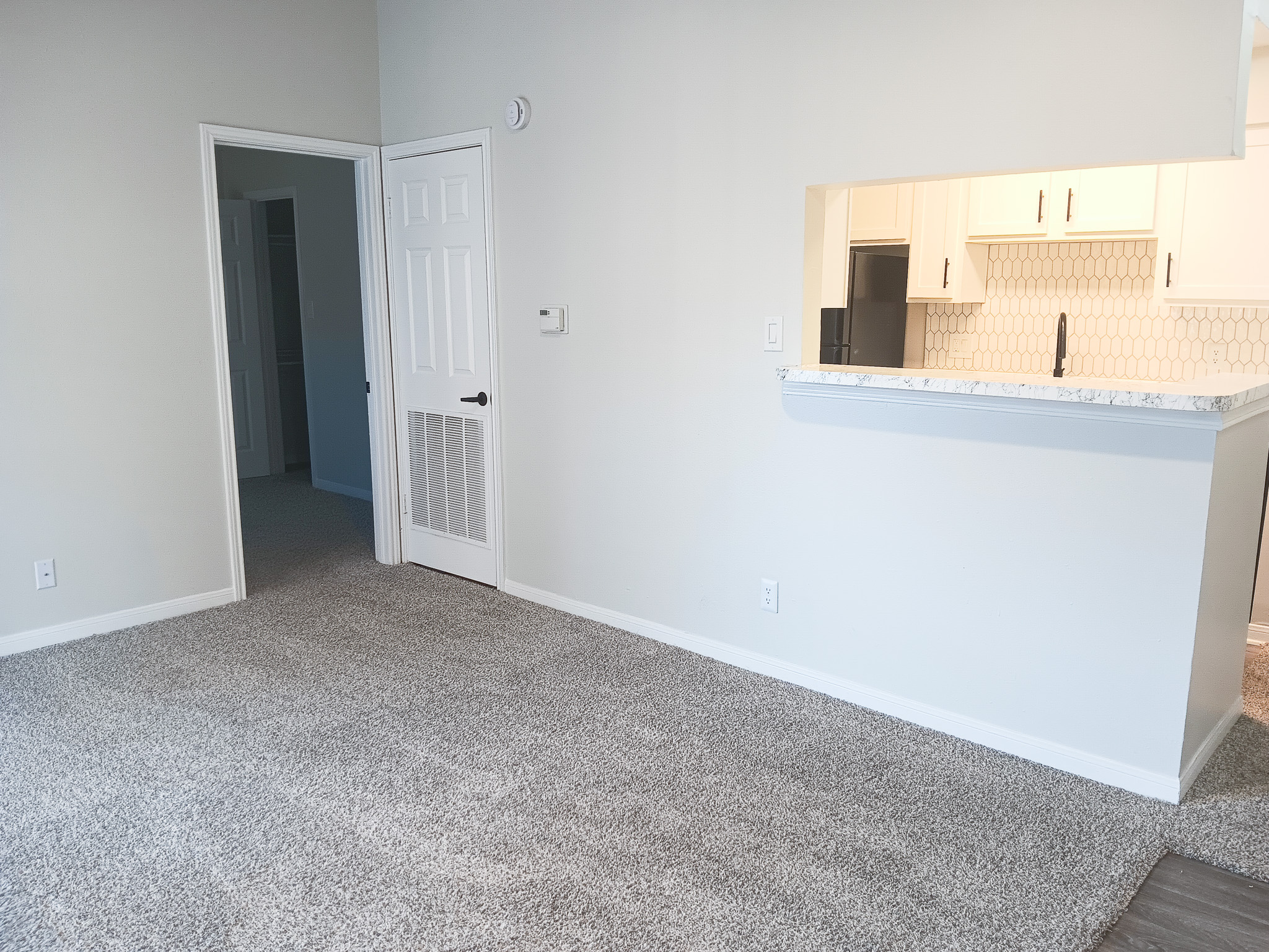 Unfurnished apartment living room and kitchen inside a home at The Woodlands