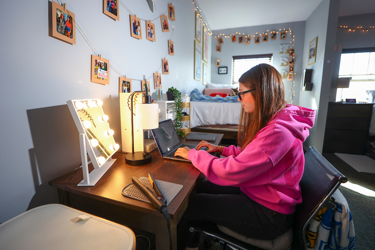 Student at desk in room of Donovan Hall