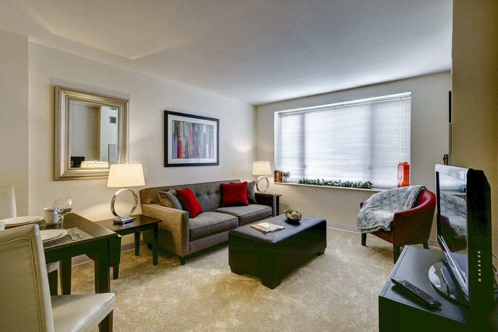 Interior image of a senior living resident's comfortable living room with plush furniture and natural light at Inspirations of Northbrook.