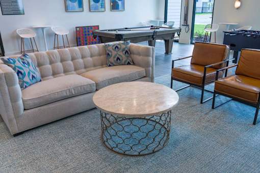 A living room with a sofa, chair, and coffee table.