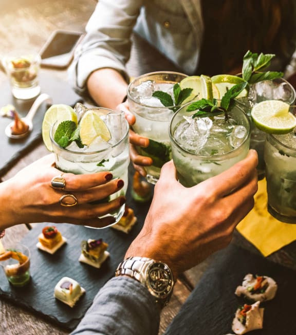 a group of people celebrating with glasses of wine