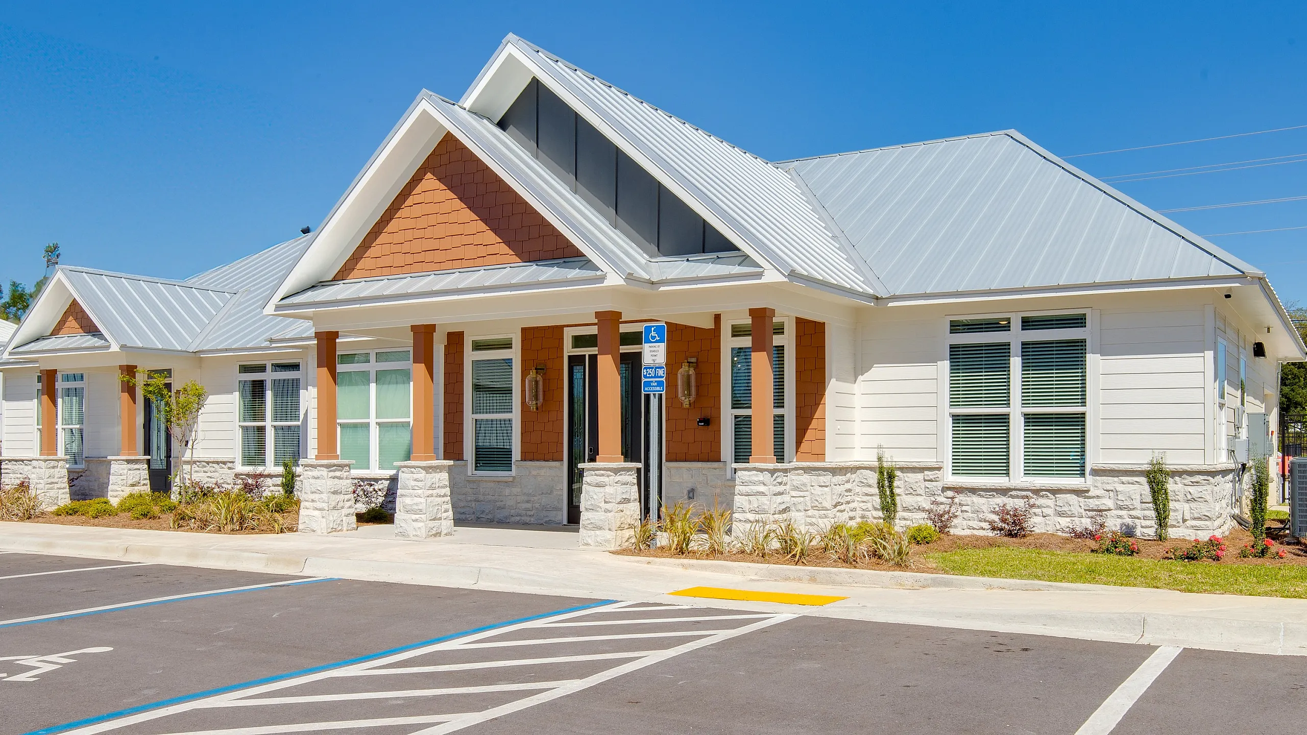 Charming modern residence with a fresh facade, inviting front porch, and pristine landscaping, perfect for comfortable living.
