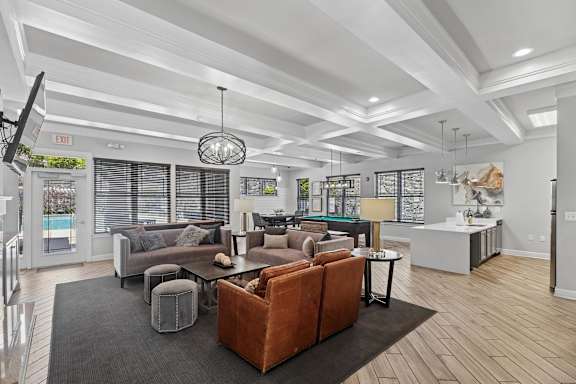 A modern living room with a large sectional sofa and a coffee table.