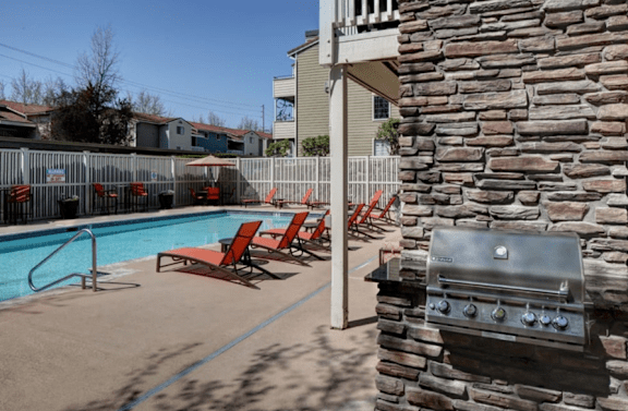 a living room with a fireplace and a pool at 2000 Lake Washington Apartments, WA, 98056
