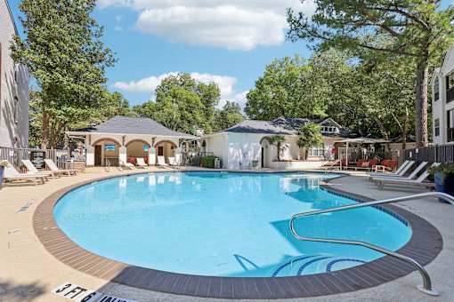 Atlanta, GA, Apartments Near Ponce City Market - Virginia Highlands - Swimming Pool with Spacious Sundeck, Lounge Chairs, Cabanas, and Trees.