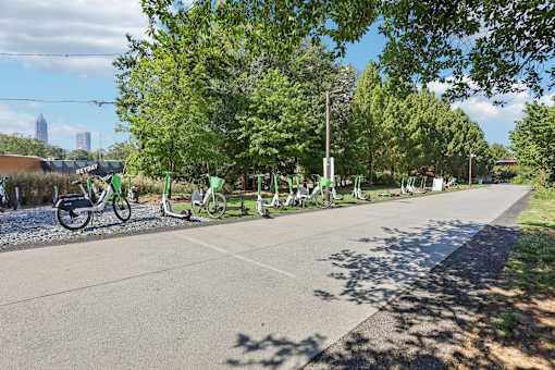 Atlanta, GA, Apartments Near The BeltLine - Virginia Highlands -  Tree-Lined Biking Trail with Shared Bikes and Pedal Scooters.