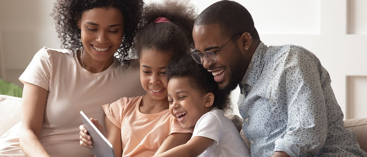 Happy family enjoying quality time together on a cozy sofa, creating joyful moments.