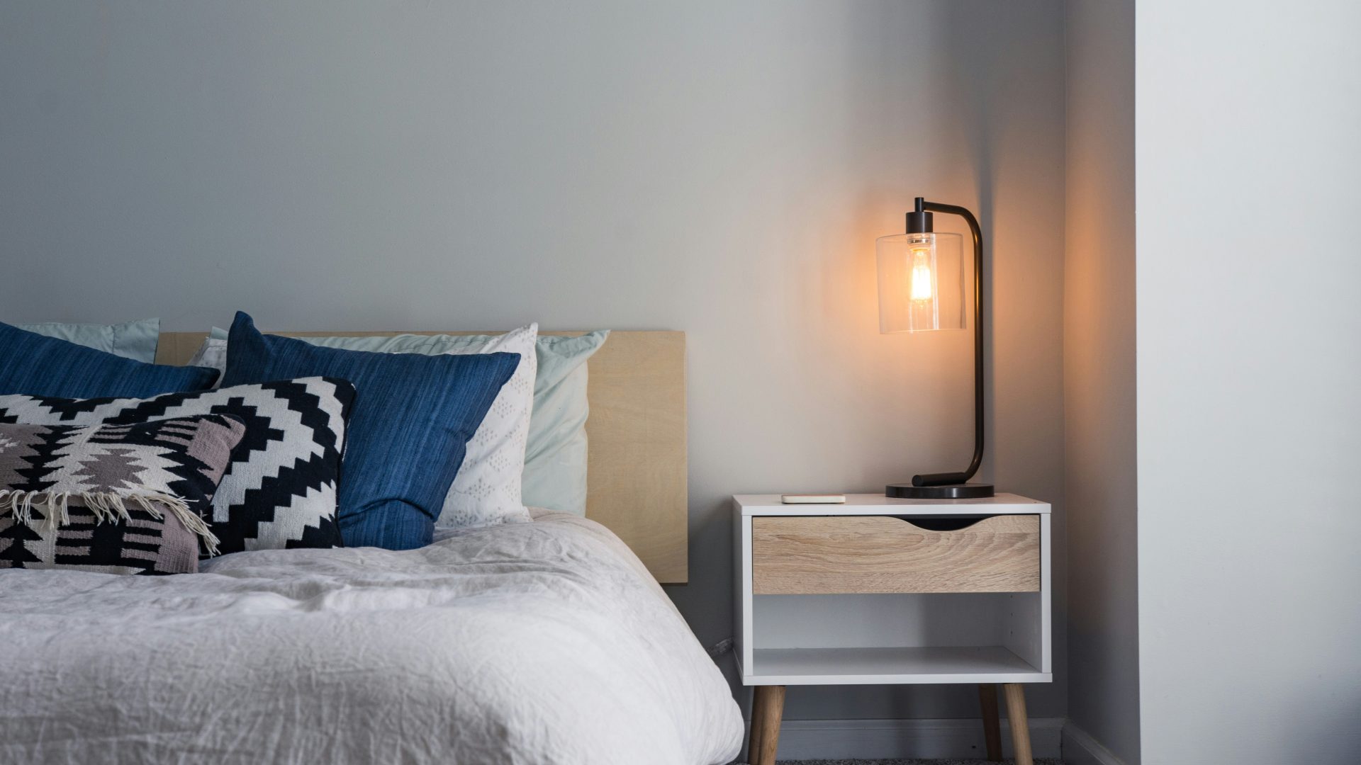 Cozy bedroom with lamp glowing in an L'Abri apartment