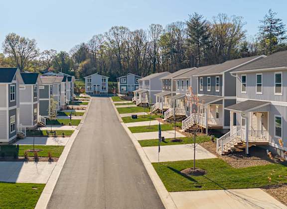 Newly built 4 bedroom rental homes in Asheville NC with porches, driveways, and landscaped yards.
