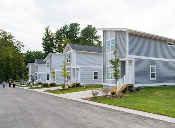 Row of modern two-story homes with driveways and porches in a suburban Asheville neighborhood.