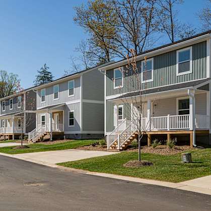 Row of modern homes for rent in Asheville, NC on a quiet suburban street.
