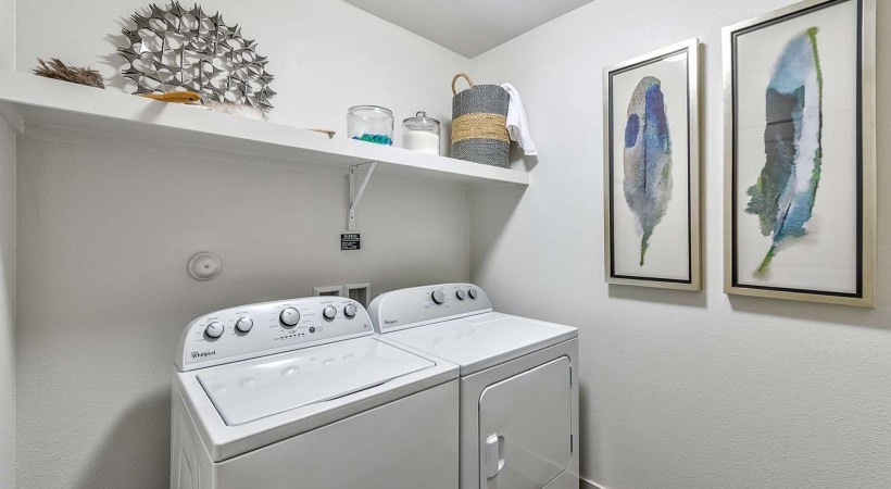 Axis 110 large laundry room with ample lighting and built-in shelf
