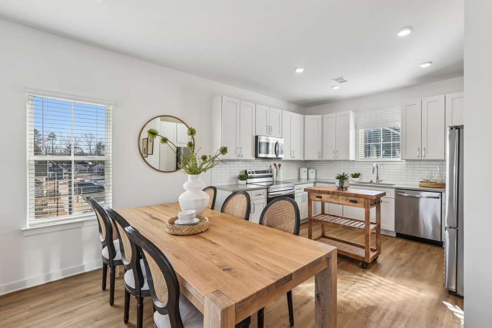 Dining area and a modern kitchen at Hamlet Quail Crossing in Wake Forest, North Carolina