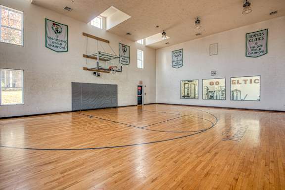 a basketball court in the center of a large room with wood floors at Residences at Stevens Pond, Massachusetts