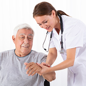 an elderly hispanic man being looked after by a nurse