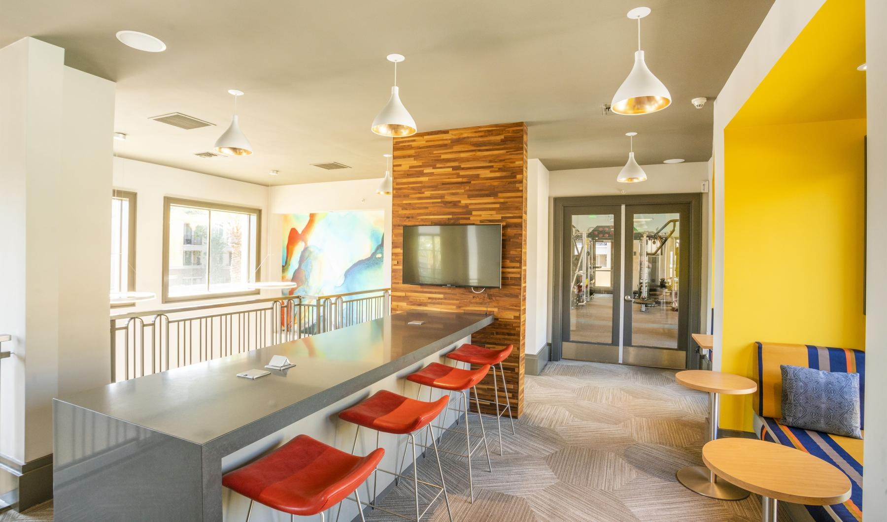a kitchen with a bar and chairs