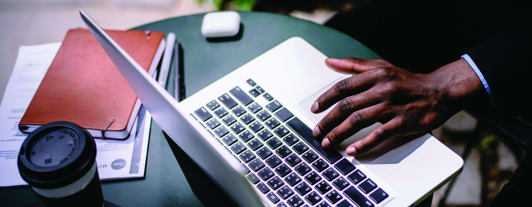 a person typing on a laptop