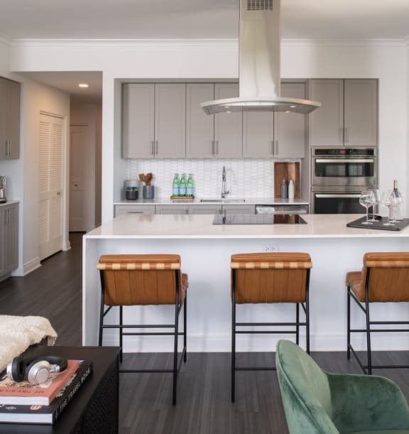 a kitchen with a white counter top and a large island with a breakfast bar at the Belden Stratford in Chicago, Illinois 60614