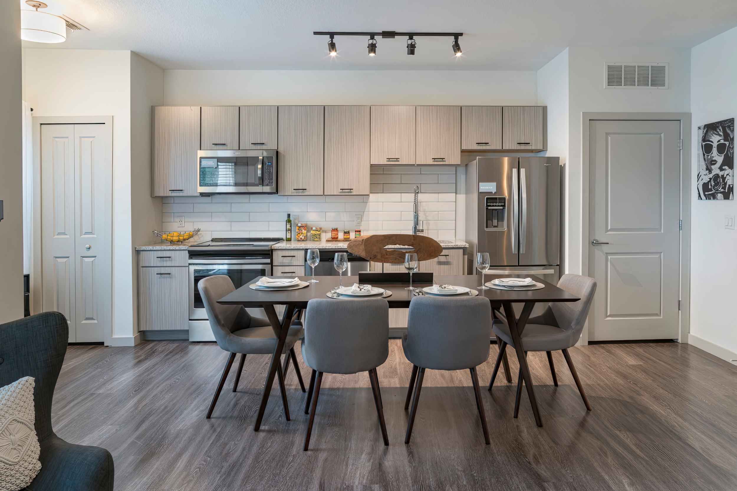 Modern kitchen and dining area with wooden accents and stylish furniture.